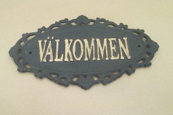 Gjutjärnsskylt: Välkommen